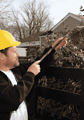 Man removing leaves from home.