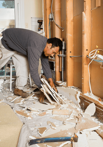 Man cleaning up a construction site