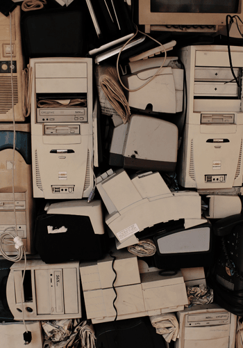 Pile of old broken computers stacked in piles