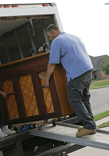 Man helping to remove a piano.