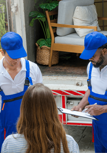 Two furniture removal experts talking to customer.