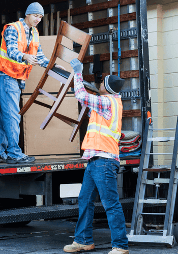 Men loading chairs onto a box truck for removal from home.