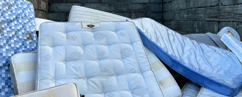 Pile of mattresses in a container