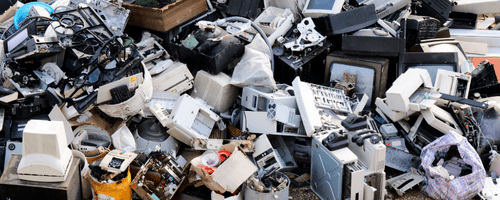 Pile of old electronic devices at recycling center