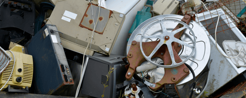 Metal parts and pieces in bin ready to be hauled off.