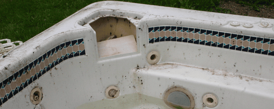 Old, run down, dirty hot tub with debris and dirt on it, that obviously needs to be removed